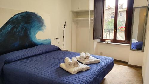 a bedroom with a bed with slippers on it at Palazzetto la Fonte in Viterbo