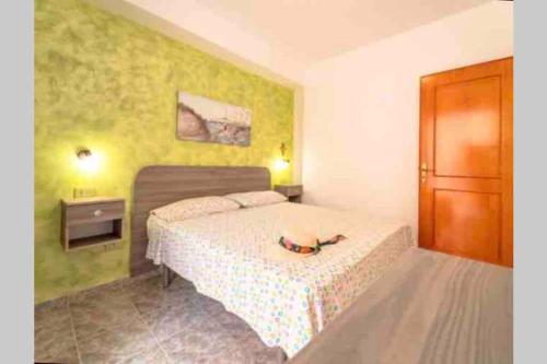 a small bedroom with a bed and a door at Via San Giacomo Primo piano in Ustica
