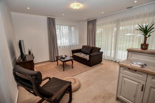 a living room with a couch and a chair at Bodrog33 Riverhouse in Tokaj