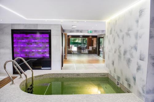 a large bathroom with a tub in the middle at Hotel Azur Siofok in Siófok