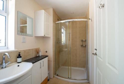 a bathroom with a shower and a sink at Avocet House in West Lulworth