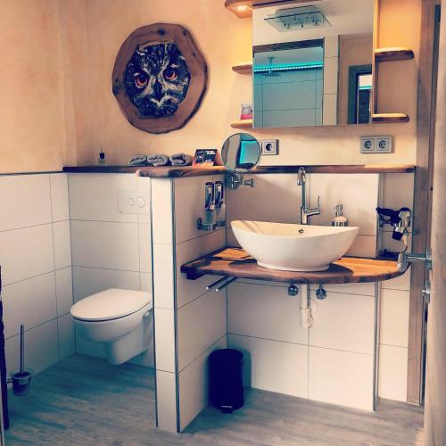 a bathroom with a sink and a toilet at Landgasthof Rebstock in Ottenhöfen