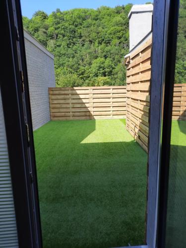 a view of a yard from a window at Vip room 209 in Trooz