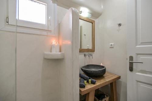 a bathroom with a sink and a mirror at Naxos Dream Oniro Studios - Adults Only in Naxos Chora