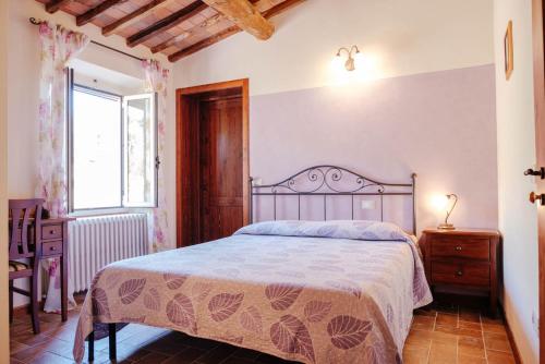 Ένα ή περισσότερα κρεβάτια σε δωμάτιο στο Agriturismo Villa Bracali