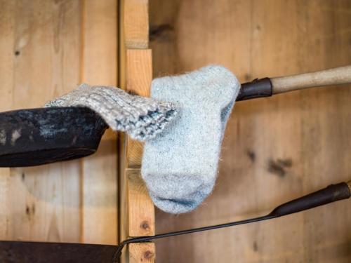 a glove and a hammer on a wooden wall at Hotel Glockenstuhl in Westendorf