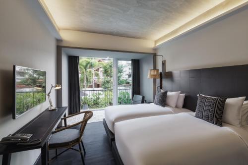 Ένα ή περισσότερα κρεβάτια σε δωμάτιο στο KIRI HOTEL Chiang Mai