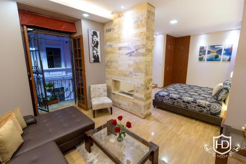 a living room with a couch and a fireplace at Hotel David in Quito