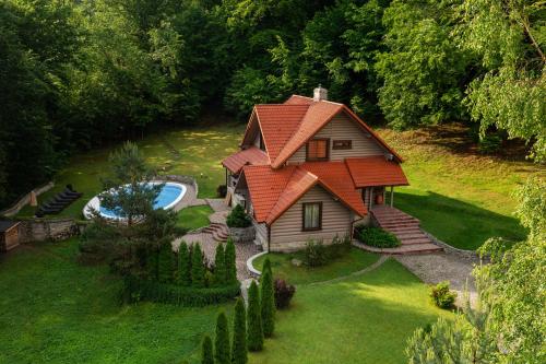an aerial view of a house with a swimming pool at Poderey Villas in Yaremche