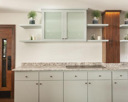 a kitchen with white cabinets and a sink at Cara Hotels Trinidad in Claxton Bay