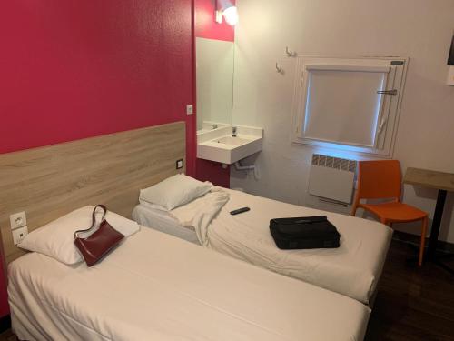 a hotel room with two beds and a sink at hotelF1 Villepinte Parc des Expositions in Villepinte