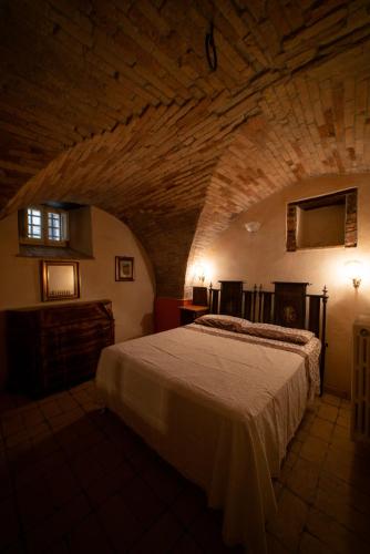 a bedroom with a large bed in a stone room at Dimora Dolce Incanto in Atri