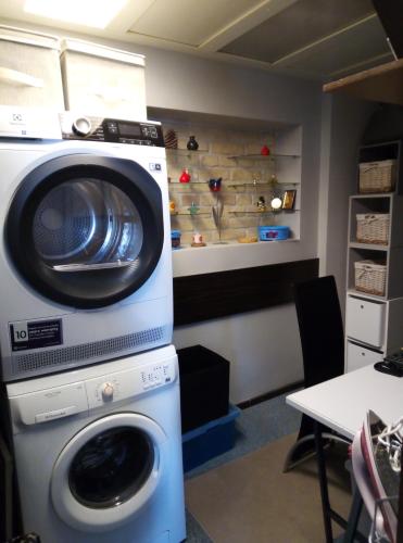 a washing machine sitting on top of a washer at HelloVilniusHostel in Vilnius