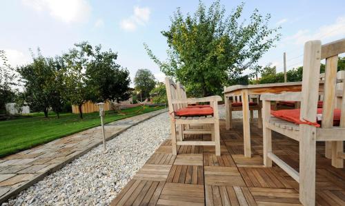 a deck with two chairs and a table and a swing at Zum goldenen Engel - Fam. Ehrenreich in Krems an der Donau
