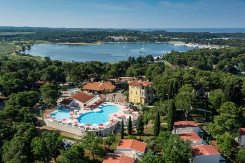 an aerial view of a resort with a pool and a lake at Apartments Bellevue Plava Laguna in Poreč