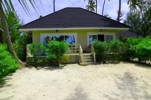 a small house on the beach with a porch at Kikoi Boutique Hotel in Michamvi