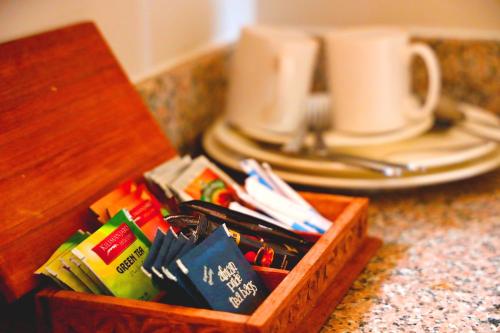 a wooden box filled with pens and pencils next to a plate at Kikoi Boutique Hotel in Michamvi