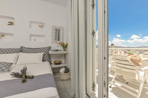 a bedroom with a bed and a balcony at Naxos Dream Oniro Studios - Adults Only in Naxos Chora