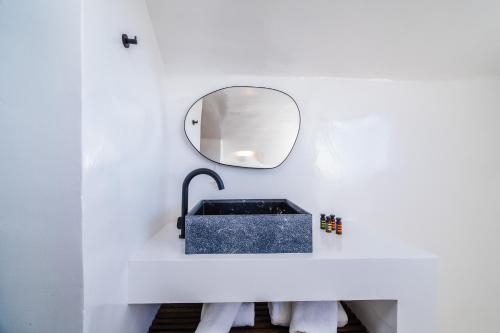 a bathroom with a black sink and a mirror at Phaos 1870, A restored Winery in Pirgos