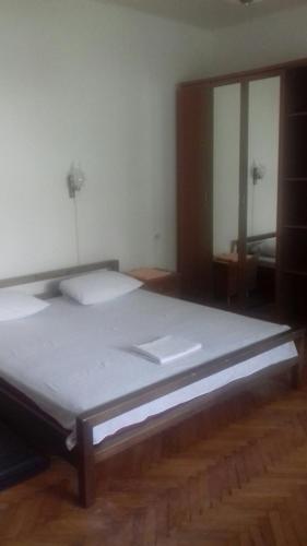 a large bed in a room with a large window at Gelena Гостьовий двір in Uzhhorod