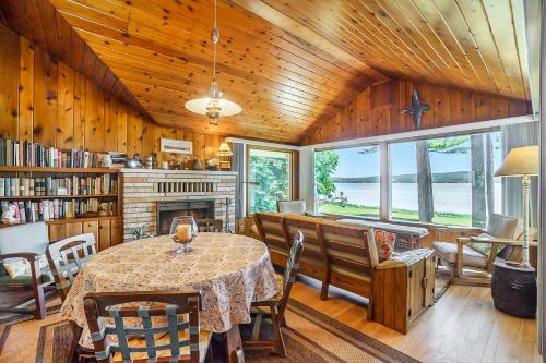 a dining room with a table and a fireplace at Serenity in Honor