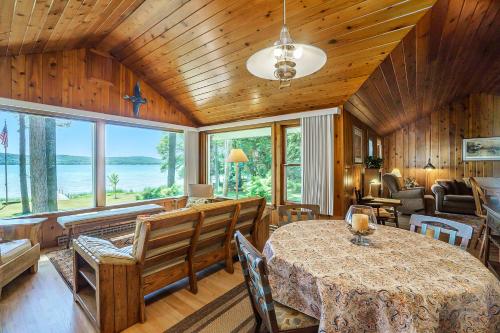 a dining room with a table and chairs and windows at Serenity in Honor