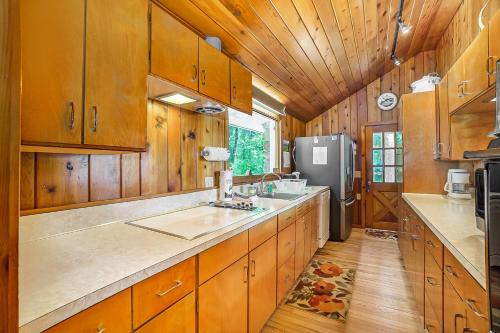 a kitchen with wooden cabinets and a refrigerator at Serenity in Honor