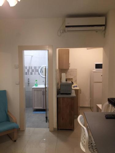 a kitchen with a table and chairs in a room at בית מרום in Gan Shomeron