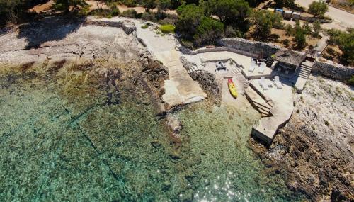 an aerial view of a house on the water at Stone House Blaca in Blato