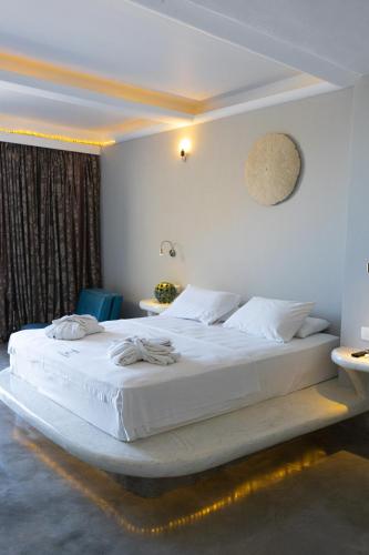 A bed or beds in a room at Demilmar Luxury Suites