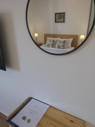 a mirror reflection of a bed in a room at Eco Apartments Kate in Suđurađ
