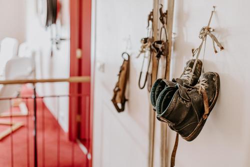 a pair of shoes hanging on a wall at Narfastadir Guesthouse in Laugar