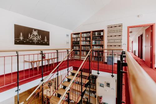 a staircase in a room with bookshelves at Narfastadir Guesthouse in Laugar