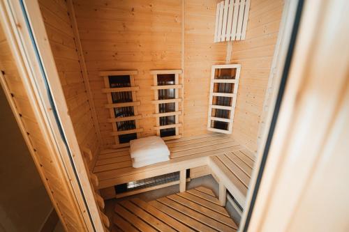 a wooden sauna with a bench in a room at Elita Hotel & Restauracja in Iwonicz-Zdrój