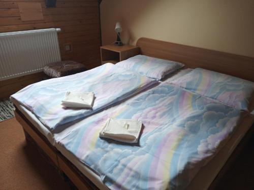 a bed with two white purses sitting on it at Penzión Zátoka in Liptovský Mikuláš
