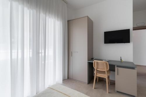 TV a/nebo společenská místnost v ubytování B&B Foglie D’ulivo