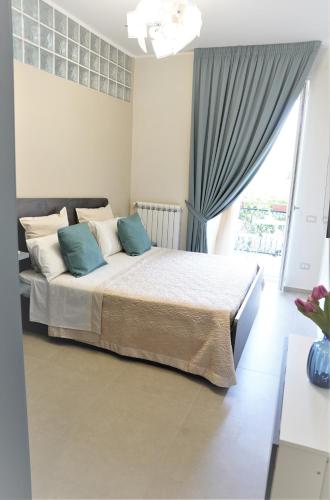 a bedroom with a large bed with blue pillows at Vesuvius' Lovely Inn in Ercolano