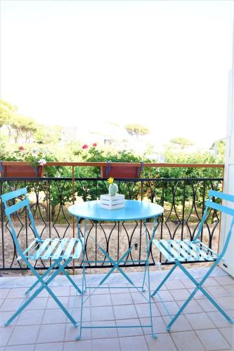 a blue table and two chairs on a balcony at Vesuvius' Lovely Inn in Ercolano