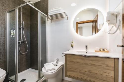 a bathroom with a sink and a shower and a toilet at Estrela de Montesinho in Bragança