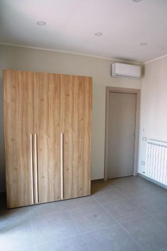 a large room with wooden cabinets and a door at Vesuvius' Lovely Inn in Ercolano