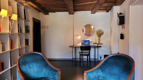 a room with two chairs and a table with a laptop at Hotel Rebstock in Luzern