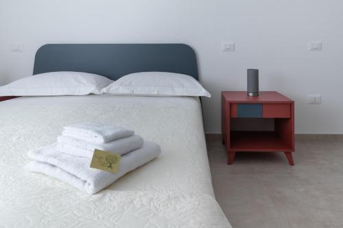 Postel nebo postele na pokoji v ubytování B&B Foglie D’ulivo