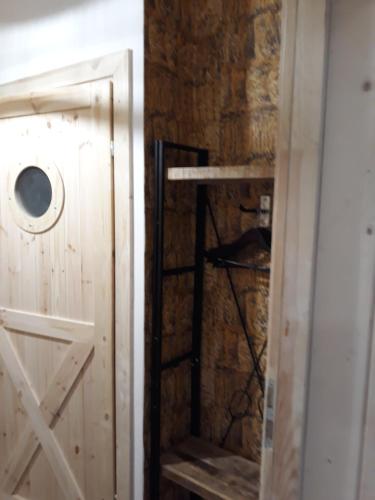 a room with a wooden door and a wall at Wioska pod Kogutem in Krępa