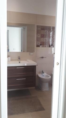 a bathroom with a sink and a toilet at Casa ERMES 151 in Floridia