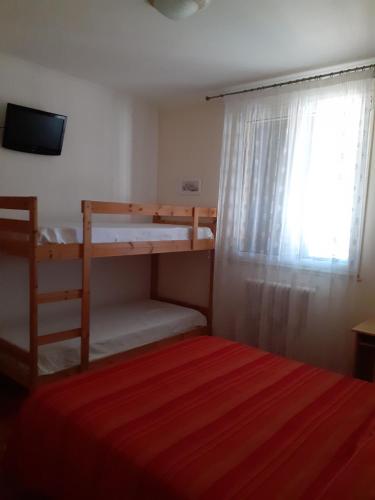 a bedroom with a bunk bed and a window at BED & BREAKFAST Villa Cerasa in Case del Bevano