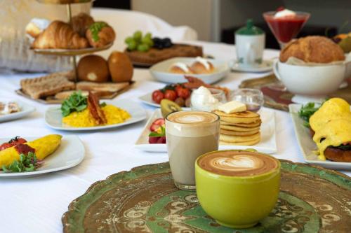 a table topped with plates of food and drinks at PALAZZO CIOTTI in Ascoli Piceno