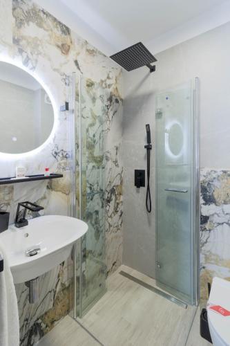 a bathroom with a sink and a shower at Kayus in Buşteni