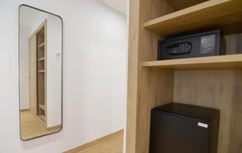 a bathroom with a microwave and a small refrigerator at UVE Marcenado in Madrid