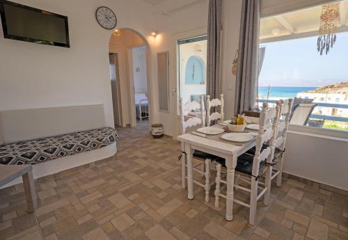 a dining room with a table and a view of the ocean at Molos Sea View House - Paros Greece in Molos Parou