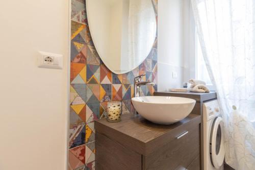 a bathroom with a bowl sink and a mirror at Le Casette Di Osvaldo in Lecco